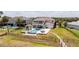 Beautiful backyard with pool, jacuzzi, and outdoor grill on a waterfront property at 16054 Johns Lake Overlook Dr, Winter Garden, FL 34787