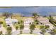 Beautiful aerial of the home on the water with boat docks on the water at 16054 Johns Lake Overlook Dr, Winter Garden, FL 34787