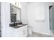 Elegant bathroom featuring a mosaic mirror, stylish vanity, and modern fixtures, creating a spa-like experience at 16054 Johns Lake Overlook Dr, Winter Garden, FL 34787