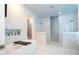 This spacious bathroom features a soaking tub and a separate shower with artistic blue and white tile at 16054 Johns Lake Overlook Dr, Winter Garden, FL 34787