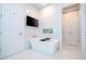 Modern bathroom features a sleek soaking tub with a built-in shelf and a wall-mounted television at 16054 Johns Lake Overlook Dr, Winter Garden, FL 34787