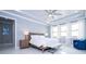 Bright bedroom with tray ceiling, plush carpets, and abundant natural light from large windows at 16054 Johns Lake Overlook Dr, Winter Garden, FL 34787