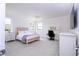 This bedroom features calm colors, large windows, and a ceiling fan that create a tranquil and inviting space at 16054 Johns Lake Overlook Dr, Winter Garden, FL 34787