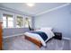 Comfortable bedroom with natural light, lake views, and a cozy workspace, perfect for relaxation and productivity at 16054 Johns Lake Overlook Dr, Winter Garden, FL 34787