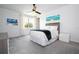 Relax in this bright bedroom with a ceiling fan, calm decorations, and lots of natural light from a big window at 16054 Johns Lake Overlook Dr, Winter Garden, FL 34787