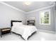 Bright bedroom with a large window, and a cozy bed at 16054 Johns Lake Overlook Dr, Winter Garden, FL 34787