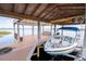 Boat lift featuring a covered roof and a sleek powerboat ready for the water at 16054 Johns Lake Overlook Dr, Winter Garden, FL 34787