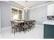 Bright dining area with a large table and seating for six, featuring a modern light fixture at 16054 Johns Lake Overlook Dr, Winter Garden, FL 34787