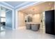 Modern dining area with sleek lighting fixture, neutral tones, and wine storage for elegant entertaining at 16054 Johns Lake Overlook Dr, Winter Garden, FL 34787