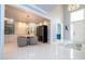 Elegant dining area featuring modern lighting, wine storage, and open access to the front entrance at 16054 Johns Lake Overlook Dr, Winter Garden, FL 34787