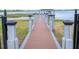 Private dock featuring a wooden walkway with black safety railings at 16054 Johns Lake Overlook Dr, Winter Garden, FL 34787
