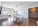 Modern game room with hardwood floors and an all white pool table, lighting and accents at 16054 Johns Lake Overlook Dr, Winter Garden, FL 34787