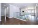 Hallway with wood floors and a glass railing overlooking the stairs at 16054 Johns Lake Overlook Dr, Winter Garden, FL 34787