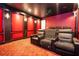A cozy home theater with comfortable seating, a projector, and soft lighting creates the perfect space for entertainment at 16054 Johns Lake Overlook Dr, Winter Garden, FL 34787