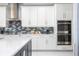 Modern kitchen with stainless steel appliances and stylish backsplash at 16054 Johns Lake Overlook Dr, Winter Garden, FL 34787