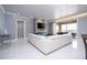 Open-concept living room with modern fireplace, large windows, and sleek tile flooring at 16054 Johns Lake Overlook Dr, Winter Garden, FL 34787