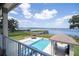 Stunning lake view featuring a pool, spa, and cabana, all within a meticulously landscaped backyard at 16054 Johns Lake Overlook Dr, Winter Garden, FL 34787
