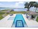 Beautiful pool area boasts a spa, outdoor kitchen, and scenic lake views, perfect for relaxing and entertaining at 16054 Johns Lake Overlook Dr, Winter Garden, FL 34787
