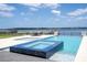 Stunning backyard pool and spa overlooking a serene lake view, perfect for relaxation at 16054 Johns Lake Overlook Dr, Winter Garden, FL 34787
