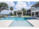 Resort-style pool with a spa, tanning ledge, and outdoor kitchen at 16054 Johns Lake Overlook Dr, Winter Garden, FL 34787