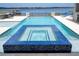 Gorgeous pool featuring a colorful tiled spa and clear water with scenic lake backdrop at 16054 Johns Lake Overlook Dr, Winter Garden, FL 34787