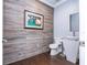 This powder room has an accent wall, vessel sink and hardwood floors at 16054 Johns Lake Overlook Dr, Winter Garden, FL 34787