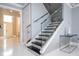 Modern staircase with glass railings and stone accents, adding elegance and style to the home's interior at 16054 Johns Lake Overlook Dr, Winter Garden, FL 34787