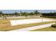 Sand volleyball court with new net surrounded by green grass and mature trees, ready for a summer game at 16054 Johns Lake Overlook Dr, Winter Garden, FL 34787