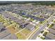 Aerial view of a community featuring sidewalks, single Gathering homes, and tree lined streets in a residential neighborhood at 1616 Eucalyptus Way, Davenport, FL 33837
