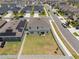 Aerial view of a large fenced backyard featuring green grass and shade trees in a sidewalk neighborhood at 1616 Eucalyptus Way, Davenport, FL 33837