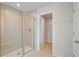 Modern bathroom featuring tiled shower, glass door, and adjoining closet at 1616 Eucalyptus Way, Davenport, FL 33837