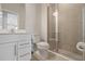 Clean bathroom with a white vanity, toilet, and glass-enclosed shower with tiled walls at 1616 Eucalyptus Way, Davenport, FL 33837
