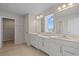 Elegant bathroom with dual vanity, white cabinets, and bright natural light at 1616 Eucalyptus Way, Davenport, FL 33837