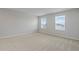 Neutral bedroom with plush carpeting and sun-filled windows overlooking the neighborhood at 1616 Eucalyptus Way, Davenport, FL 33837