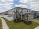 Two-story home features a well-maintained lawn, a two-car garage, and a white fence surrounding the perimeter at 1616 Eucalyptus Way, Davenport, FL 33837