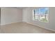 Minimalist living room with tile floors, a large window, and a neutral color palette at 1616 Eucalyptus Way, Davenport, FL 33837