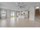 Bright and airy living room featuring an open layout to the kitchen and tile floors at 1616 Eucalyptus Way, Davenport, FL 33837