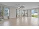 Bright and airy living room with tile floors, large windows and neutral color palette at 1616 Eucalyptus Way, Davenport, FL 33837