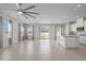 Bright and airy living room featuring an open layout to the kitchen and tile floors at 1616 Eucalyptus Way, Davenport, FL 33837