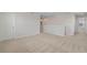 Upstairs loft area with neutral carpeting, white walls, and access to bedrooms at 1616 Eucalyptus Way, Davenport, FL 33837