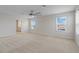 Spacious main bedroom with three sunny windows and modern ceiling fan fixture at 1616 Eucalyptus Way, Davenport, FL 33837