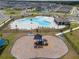 An aerial perspective highlighting the community pool, playground, and surrounding residential area at 1616 Eucalyptus Way, Davenport, FL 33837