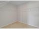 Cozy walk-in closet with neutral carpeting and built-in shelving for optimal storage at 1616 Eucalyptus Way, Davenport, FL 33837
