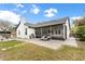 Spacious backyard featuring a patio, well-maintained lawn, and an outdoor grill for enjoyable outdoor living at 1667 Spring Loop Way, Winter Garden, FL 34787