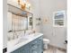 Elegant bathroom featuring dual sinks, marble countertops, modern fixtures, and a window for natural light at 1667 Spring Loop Way, Winter Garden, FL 34787