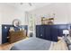 Cozy bedroom featuring board and batten, comfy bed, warm wood dresser and decor for a relaxing space at 1667 Spring Loop Way, Winter Garden, FL 34787