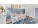 Stylish bedroom featuring board and batten accent wall, matching furniture and eye-catching floral rug at 1667 Spring Loop Way, Winter Garden, FL 34787