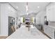 Modern kitchen features stainless steel appliances, a large island, and a view into the living room at 1667 Spring Loop Way, Winter Garden, FL 34787