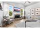 Beautiful living room showcases a brick fireplace, large windows, and comfortable seating at 1667 Spring Loop Way, Winter Garden, FL 34787