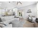Bright living room offers vaulted ceiling, ample seating, and easy access to the kitchen and backyard at 1667 Spring Loop Way, Winter Garden, FL 34787